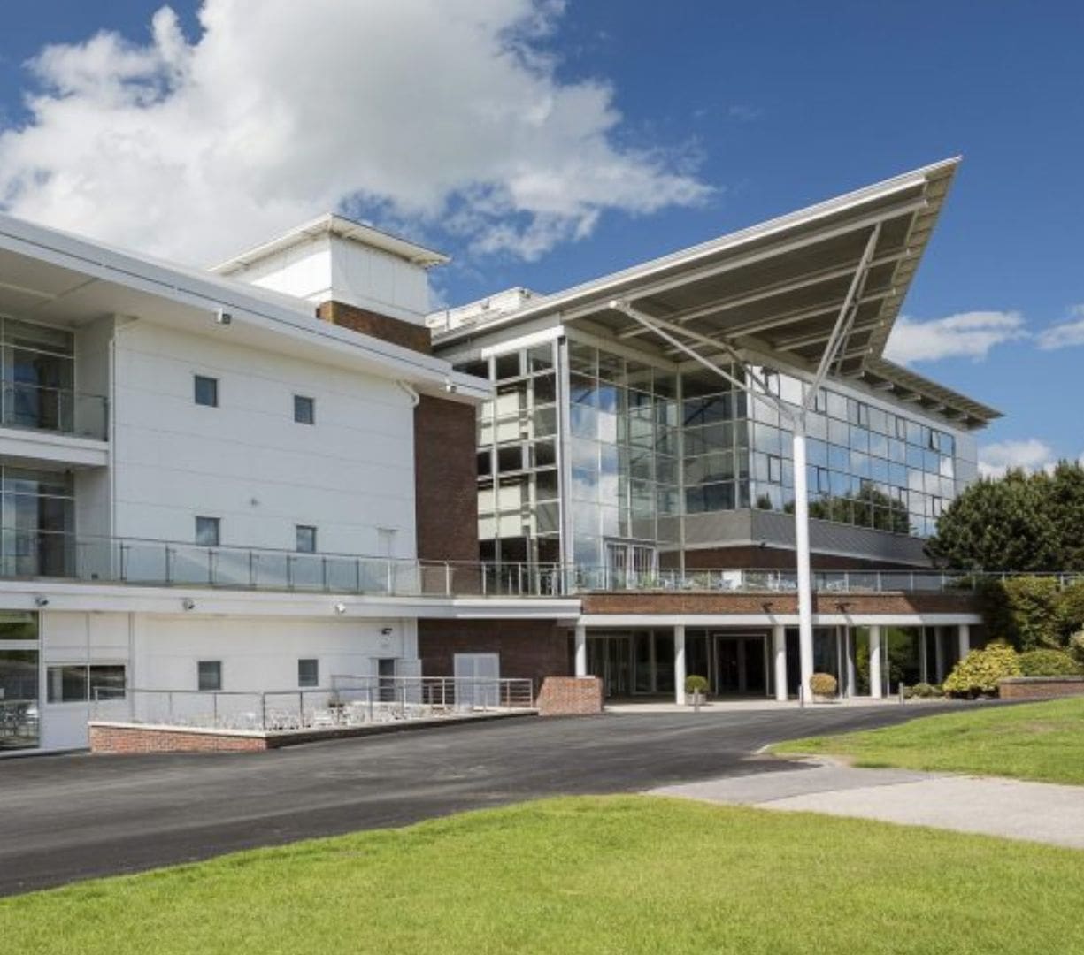 A sunny day at Wetherby Racecourse showing an image of the outside of the Millennium Stand and Millennium west with views of the balcony on both stands